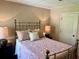 Cozy bedroom featuring soft lighting, plush bedding, neutral walls, and vintage brass bed frame with ample natural light at 117 Manous Dr, Canton, GA 30115