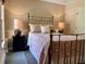 Cozy bedroom with an iron bed frame, soft lighting and patterned bedding at 117 Manous Dr, Canton, GA 30115