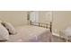 Bedroom with neutral colored walls, white trim, and bed with floral bedding, with a rattan chair at 117 Manous Dr, Canton, GA 30115