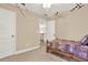 Bedroom with neutral carpet, neutral colored walls, and a single bed, adjacent to an open doorway at 117 Manous Dr, Canton, GA 30115
