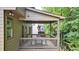 Covered deck featuring neutral exterior paint, wood railings, and outdoor dining set at 117 Manous Dr, Canton, GA 30115