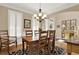 Dining room featuring hardwood floors, plantation shutters, chandelier, and elegant furniture at 117 Manous Dr, Canton, GA 30115