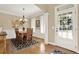 Elegant dining area with hardwood floors, large windows, and wainscoting detail at 117 Manous Dr, Canton, GA 30115