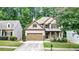 Charming two-story home with brick and siding exterior, two-car garage, covered porch, and professionally landscaped front yard at 117 Manous Dr, Canton, GA 30115