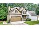 Charming two-story home with brick and siding exterior, two-car garage, covered porch, and professionally landscaped front yard at 117 Manous Dr, Canton, GA 30115