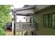 Exterior featuring an upper and lower-level deck and backyard with lush greenery at 117 Manous Dr, Canton, GA 30115