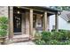 Welcoming brick front porch featuring classic columns, stylish decor, and a cozy seating area at 117 Manous Dr, Canton, GA 30115
