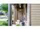 A cozy brick front porch featuring columns, a bench, and stylish lantern lighting at 117 Manous Dr, Canton, GA 30115