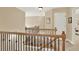 Hallway with carpet, neutral colored walls, white trim and a wood railing with dark metal accents at 117 Manous Dr, Canton, GA 30115