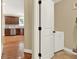 A hallway leading to the kitchen with hardwood floors and stainless steel appliances at 117 Manous Dr, Canton, GA 30115