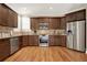 Spacious kitchen featuring dark wood cabinets, stainless steel appliances, and hardwood floors at 117 Manous Dr, Canton, GA 30115