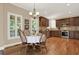 Eat-in kitchen with dark wood cabinets, stainless steel appliances, and hardwood floors at 117 Manous Dr, Canton, GA 30115