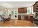 Eat-in kitchen with wood floors, dark wood cabinets and stainless steel appliances at 117 Manous Dr, Canton, GA 30115