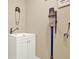 A modern laundry room with a sink, white cabinets, and a mounted vacuum at 117 Manous Dr, Canton, GA 30115