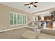 Bright living room with large windows, seamlessly connecting to the kitchen, creating an inviting space at 117 Manous Dr, Canton, GA 30115