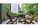 Cozy patio with Adirondack chairs around a fire pit, surrounded by landscaping at 117 Manous Dr, Canton, GA 30115