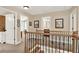 Open upstairs landing offering views into other rooms and featuring a beautiful wood and iron railing at 117 Manous Dr, Canton, GA 30115