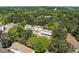 An aerial view of the townhome complex nestled among mature trees with highway in background at 223 Chads Ford Way, Roswell, GA 30076