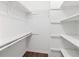 A walk-in closet with built-in shelving and hardwood floors at 223 Chads Ford Way, Roswell, GA 30076