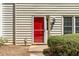 Up-close view of a bright red front door with modern fixtures and manicured landscaping in a townhome community at 223 Chads Ford Way, Roswell, GA 30076