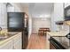 A kitchen featuring white cabinets, modern appliances, and a dining area at 223 Chads Ford Way, Roswell, GA 30076