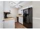 Bright kitchen featuring white cabinets, hardwood floors, and modern black appliances at 223 Chads Ford Way, Roswell, GA 30076