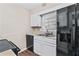 Modern kitchen with white cabinetry, hardwood floors, and a large stainless steel refrigerator at 223 Chads Ford Way, Roswell, GA 30076