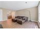 Open-concept living room features hardwood floors and a comfortable leather sofa with ottoman at 223 Chads Ford Way, Roswell, GA 30076