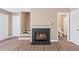 Cozy living room features hardwood floors and a gas fireplace with tiled hearth at 223 Chads Ford Way, Roswell, GA 30076