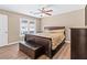 A well-lit main bedroom featuring a ceiling fan and ample natural light from the window at 223 Chads Ford Way, Roswell, GA 30076