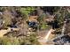 Aerial view of a home in Cumming on +/- 0.59 acres surrounded by trees and nature at 3235 Crestview Dr, Cumming, GA 30041