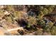 An aerial view showing the property nestled amongst mature trees with a long driveway and ample space at 3235 Crestview Dr, Cumming, GA 30041