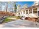 The backyard features a concrete patio, green grass, and mature trees offering shade and privacy at 3235 Crestview Dr, Cumming, GA 30041