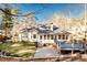 Backyard featuring a deck, patio, and lush greenery surrounded by mature trees at 3235 Crestview Dr, Cumming, GA 30041