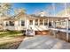 Backyard featuring a deck, patio, and lush greenery surrounded by mature trees at 3235 Crestview Dr, Cumming, GA 30041