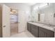 Bathroom featuring a double sink vanity, granite countertop, and view of bedroom at 3235 Crestview Dr, Cumming, GA 30041