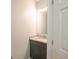 Bathroom featuring a grey vanity with granite countertop, a framed mirror, and white door at 3235 Crestview Dr, Cumming, GA 30041