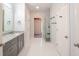 Bathroom featuring a gray vanity, granite countertop, glass shower and a view of a closet at 3235 Crestview Dr, Cumming, GA 30041