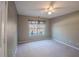 Bedroom featuring neutral carpet and wall paint with a single window and ceiling fan at 3235 Crestview Dr, Cumming, GA 30041
