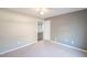 Bedroom with neutral colored walls and carpet with view to adjacent room at 3235 Crestview Dr, Cumming, GA 30041