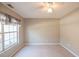 Bedroom featuring neutral carpet and wall paint with a single window and ceiling fan at 3235 Crestview Dr, Cumming, GA 30041