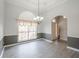 Dining room features tray ceilings, laminate flooring and large window letting in tons of natural light at 3235 Crestview Dr, Cumming, GA 30041