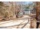 Two-story home with a long driveway, stone facade, and partial fencing at 3235 Crestview Dr, Cumming, GA 30041