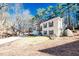 Exterior shot of home nestled in a wooded area, showcasing its architectural design and landscaping at 3235 Crestview Dr, Cumming, GA 30041