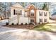 Elegant two-story home with a blend of stone and siding, a well-kept lawn, and inviting front entry at 3235 Crestview Dr, Cumming, GA 30041