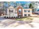 Inviting two-story home featuring a well-manicured lawn, stone accents, and beautiful curb appeal at 3235 Crestview Dr, Cumming, GA 30041