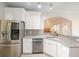 Bright kitchen with granite countertops, stainless steel appliances, and white cabinets at 3235 Crestview Dr, Cumming, GA 30041
