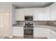 Modern kitchen boasts white cabinets, granite countertops, and stainless steel appliances at 3235 Crestview Dr, Cumming, GA 30041