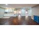 Open living space featuring a small kitchen area, hardwood floors, and ample natural light at 3235 Crestview Dr, Cumming, GA 30041