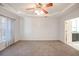 Large main bedroom featuring trey ceilings, ceiling fan, plush carpet, and ample natural light at 3235 Crestview Dr, Cumming, GA 30041